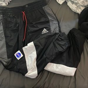 Mens Medium Adidas tapered slim NASA track pants.